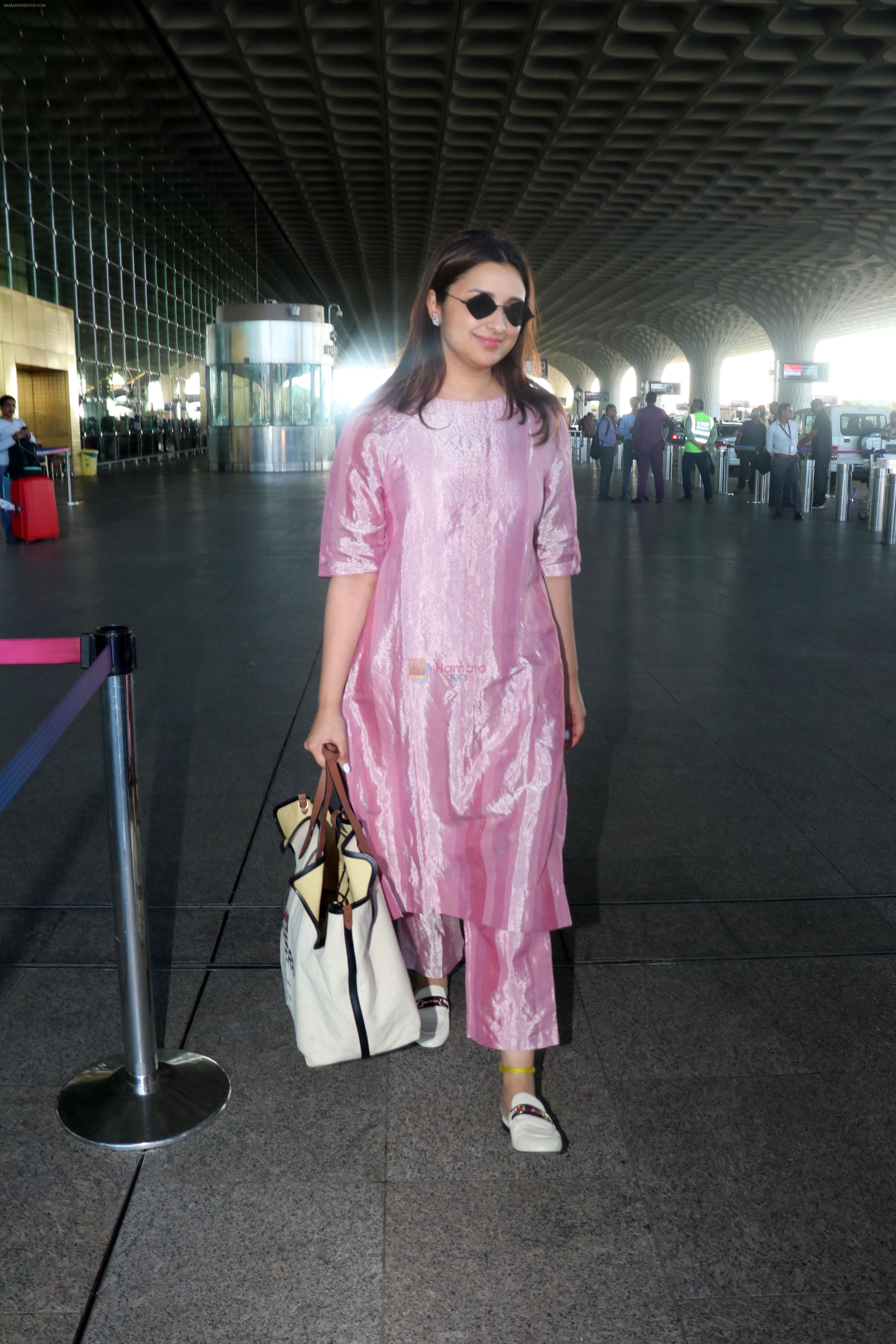Parineeti Chopra wearing a bright pink dress white shoes sunglasses 